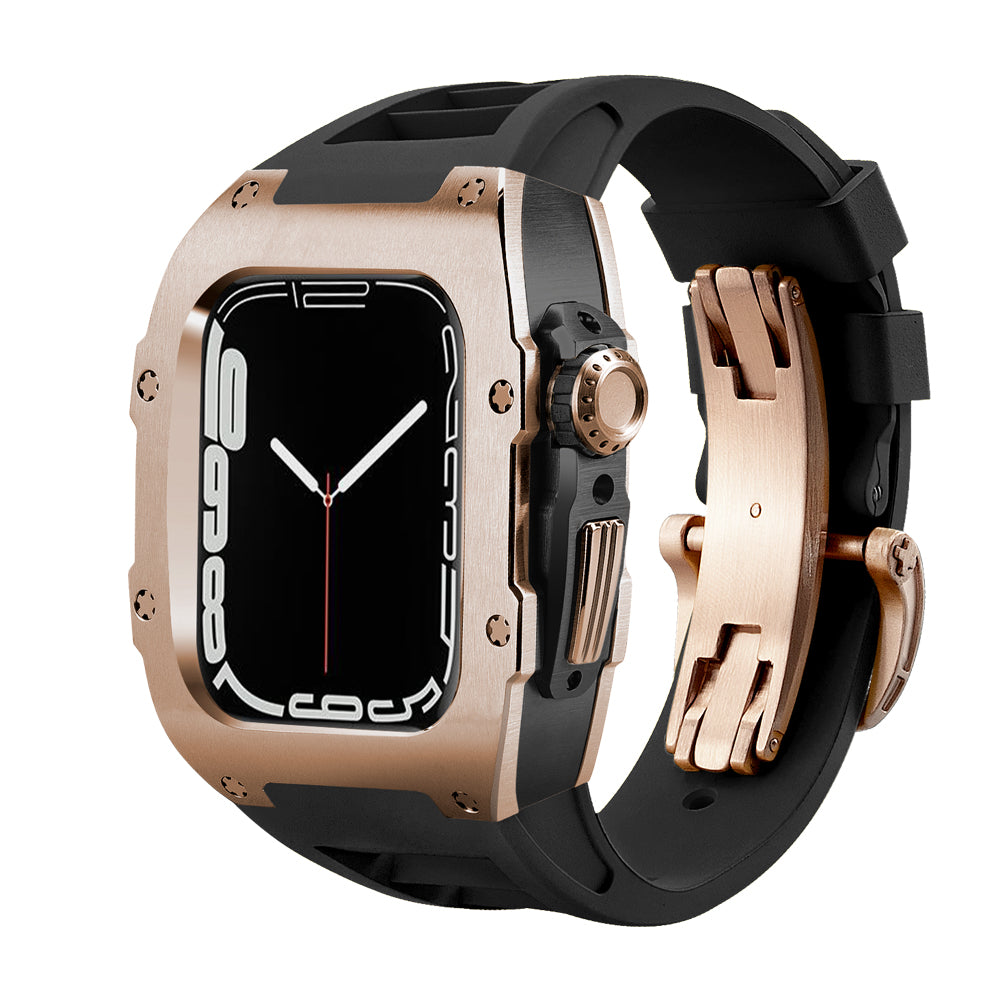Ken Sailor T Rose Gold Apple Watch conversion case featuring a brushed rose-gold alloy housing, black internal chassis, and black performance rubber strap with matching rose-gold deployment clasp. Motorsport-inspired squared case profile with exposed screw details and full crown + button cutout. Designed to transform the Apple Watch into a premium mechanical timepiece aesthetic, photographed at a three-quarter angle with high-contrast lighting on a clean white background.