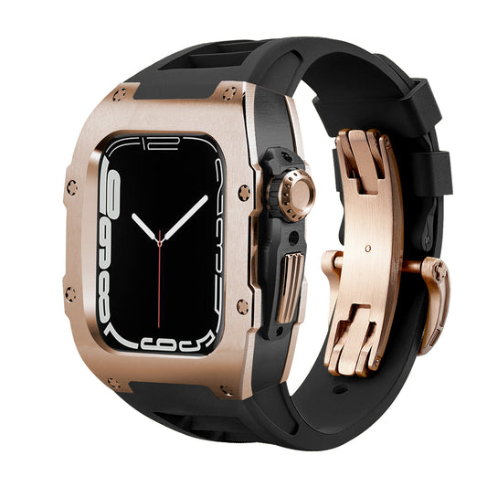 Ken Sailor T Rose Gold Apple Watch conversion case featuring a brushed rose-gold alloy housing, black internal chassis, and black performance rubber strap with matching rose-gold deployment clasp. Motorsport-inspired squared case profile with exposed screw details and full crown + button cutout. Designed to transform the Apple Watch into a premium mechanical timepiece aesthetic, photographed at a three-quarter angle with high-contrast lighting on a clean white background.