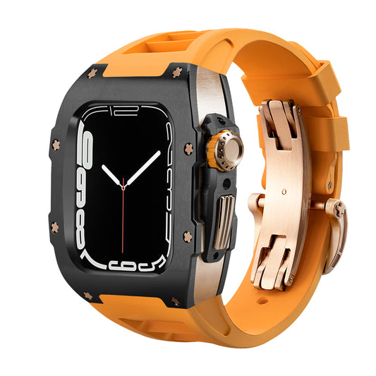 Ken Sailor T Series conversion kit for Apple Watch Ultra featuring a matte black bezel, rose gold mid-case components, and a bright orange silicone sports strap with deployment clasp for a premium racing-inspired aesthetic.
