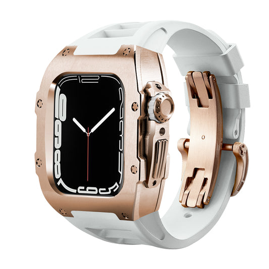 Ken Sailor T Series rose metal protective case for Apple Watch Ultra paired with white silicone performance band and matching deployment clasp, designed to convert the smartwatch into a luxury-style wrist timepiece.

