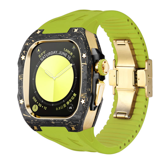 forged carbon apple watch case with gold hardware and green silicone strap, front angled product photo of high end luxury apple watch ultra conversion kit with deployant clasp and carbon marbling accents for ecommerce listing